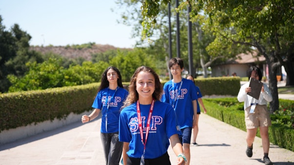 Studentls walking through a courtyard