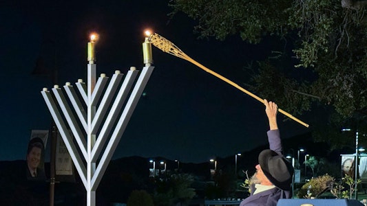 Person lighting the Menorah