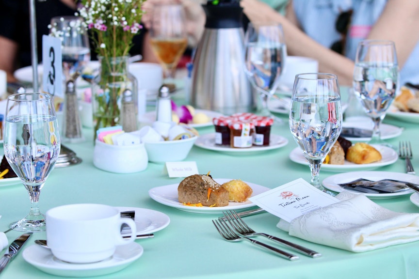 Tea Time Table set for Tea. Desserts, breads , and jelly.