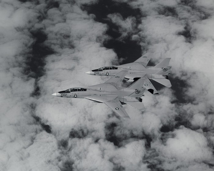 An air-to-air left side view of two F-14 Tomcat aircraft