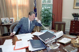 Reagan on phone at his desk