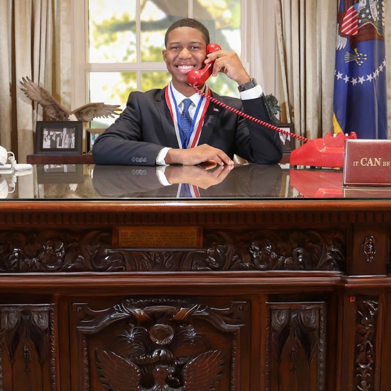 Student on phone in oval office