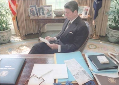 Reagan reading in oval office