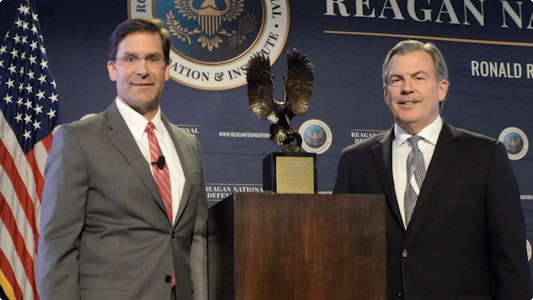 Two men smiling at podium