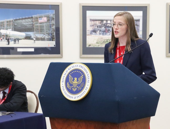 Young girl speaking at podium