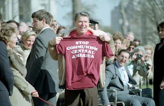 President Reagan holding a stop communism central america shirt