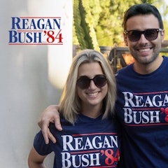 Man and woman smiling in backyard wearing shirts that read Reagan Bush 84