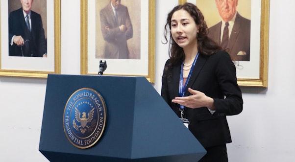 Female debate participant at the podium