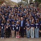 Students posing for a photo along a flight of stairs