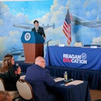 2 students, each on a podium for the debate